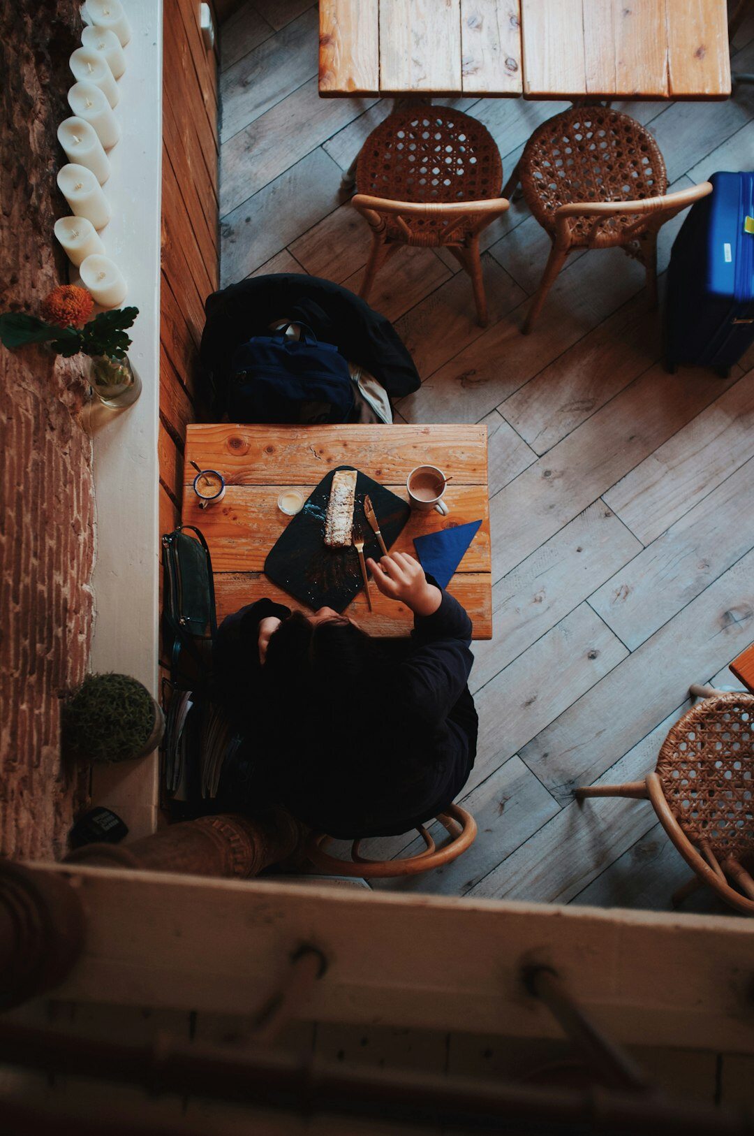 woman writing in notebook at cafe