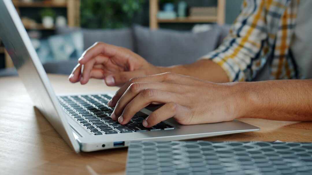 author typing on laptop