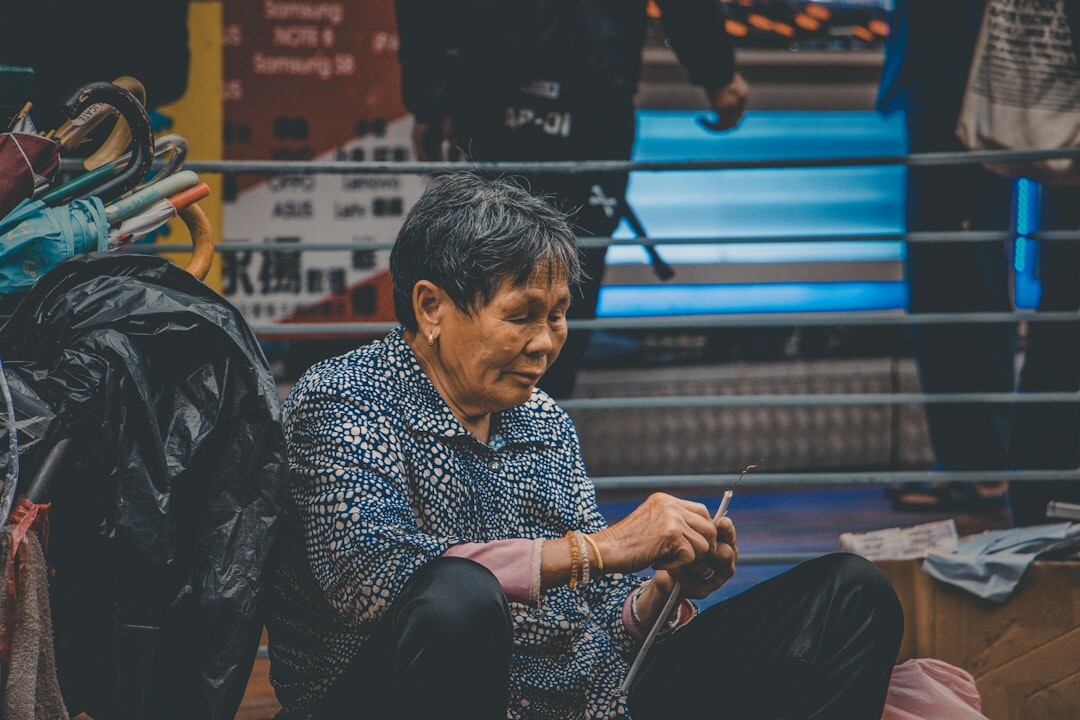 Elderly woman knitting during a craft workshop