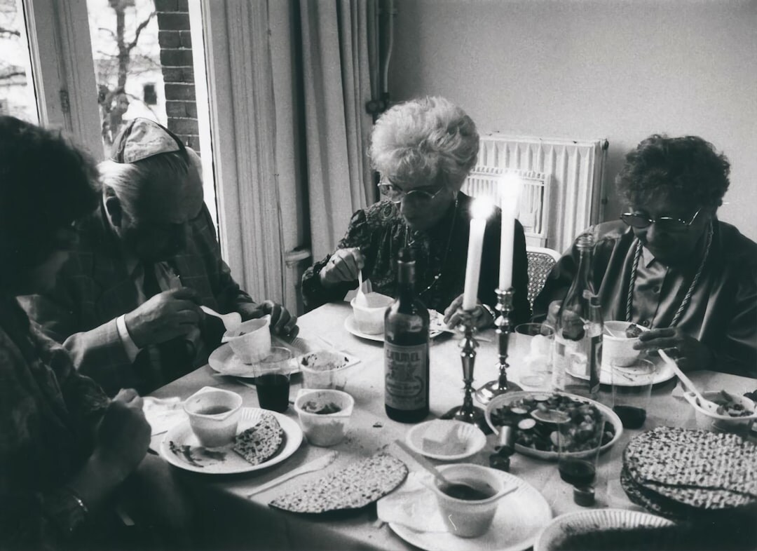 Elderly friends drinking tea and chatting at a table