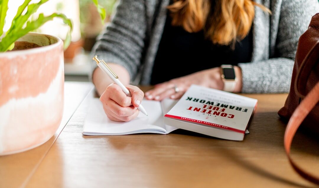 writer sitting at desk with notebook
